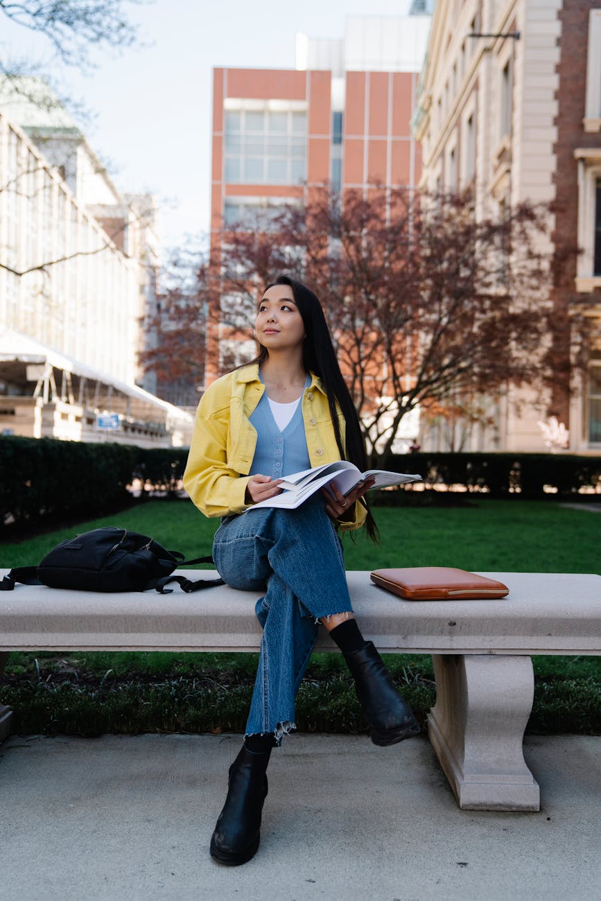 college girl sitting on a bench with her notes